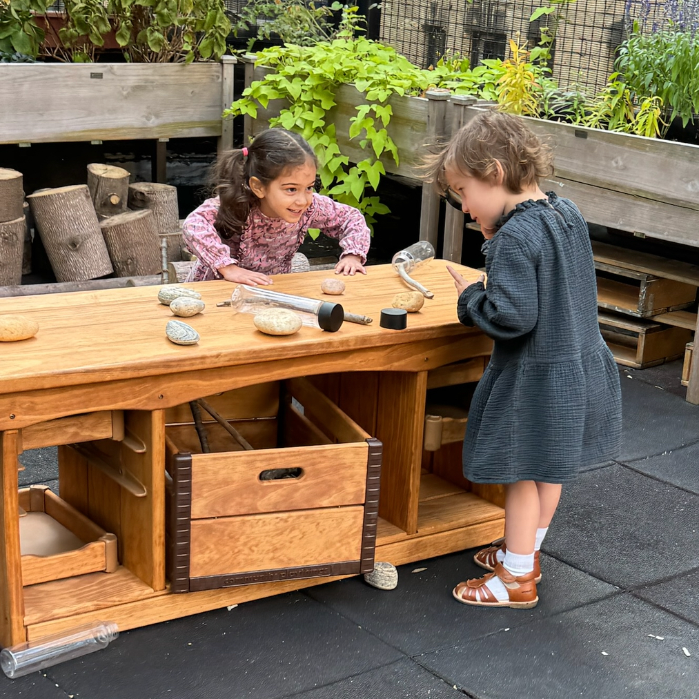 two girls playing outside on a rooftop